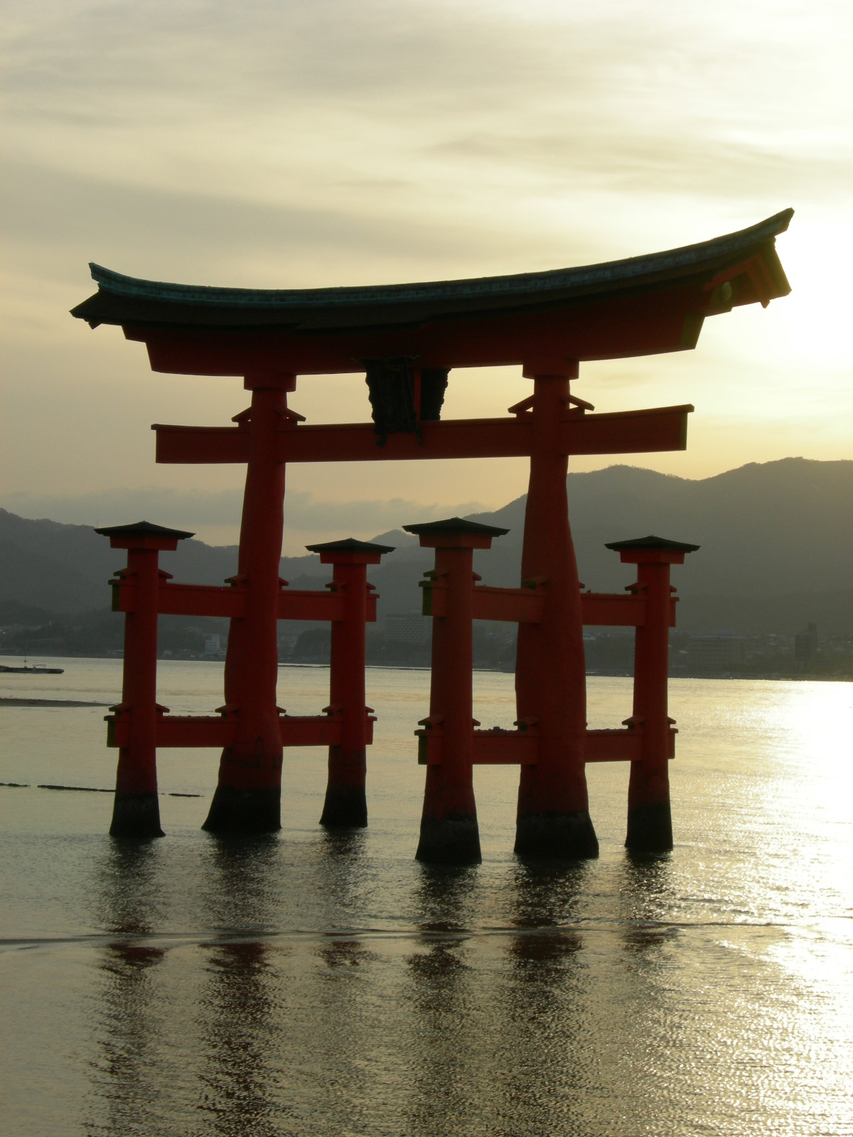 The Great Torii of Itsukushima appearing to float on the sea at sunrise