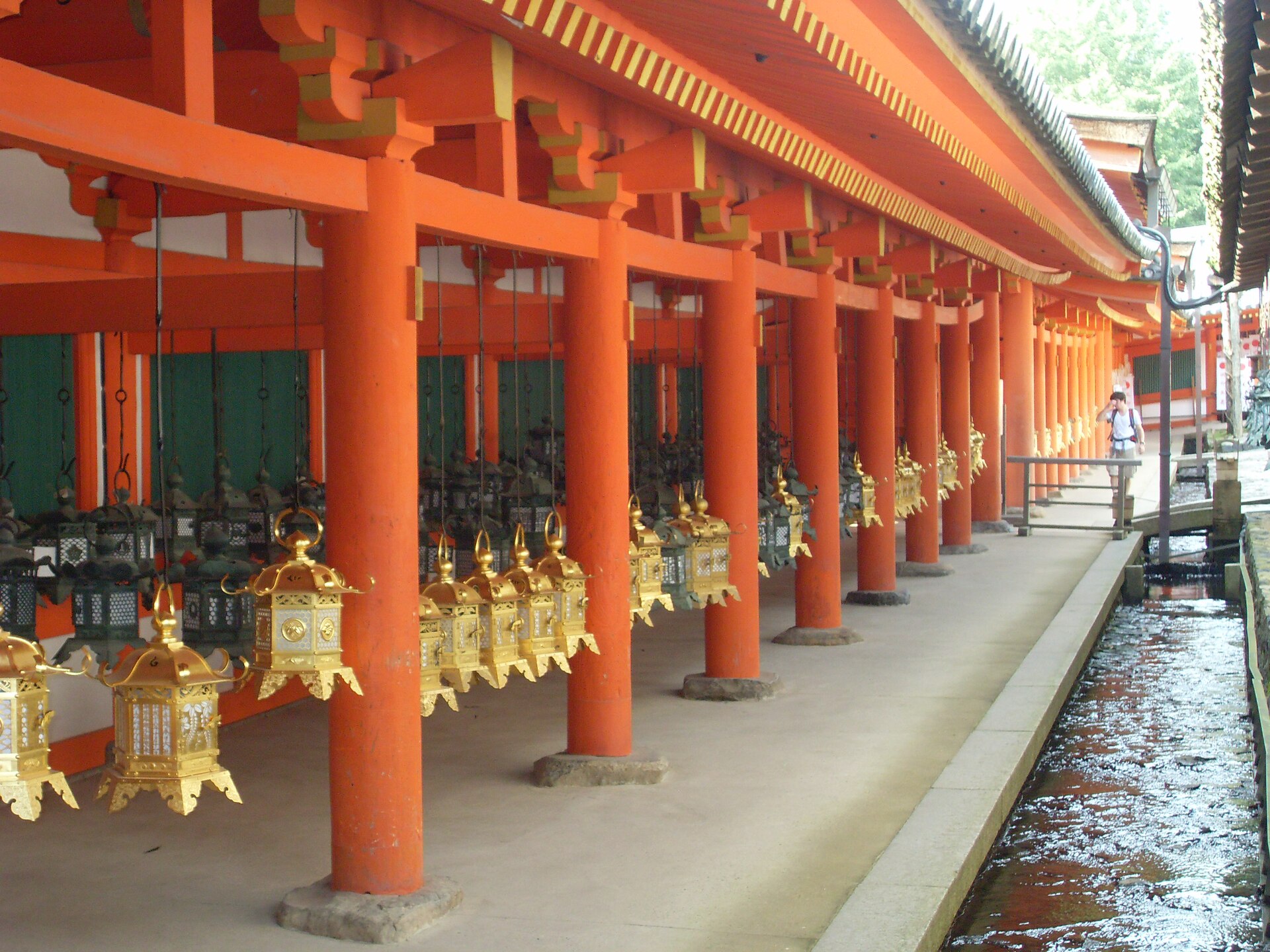 Rows of bronze votive lanterns hanging along the corridors of Kasuga Taisha