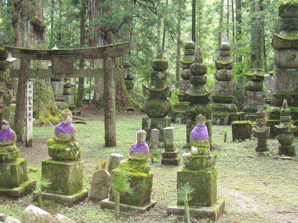 Moss-covered pagodas among towering cedars on the Okunoin approach at Koyasan
