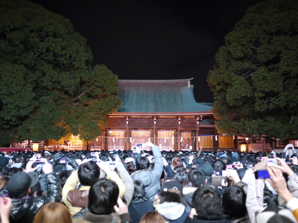 New Year visitors at Meiji Jingu in Tokyo at night during hatsumode