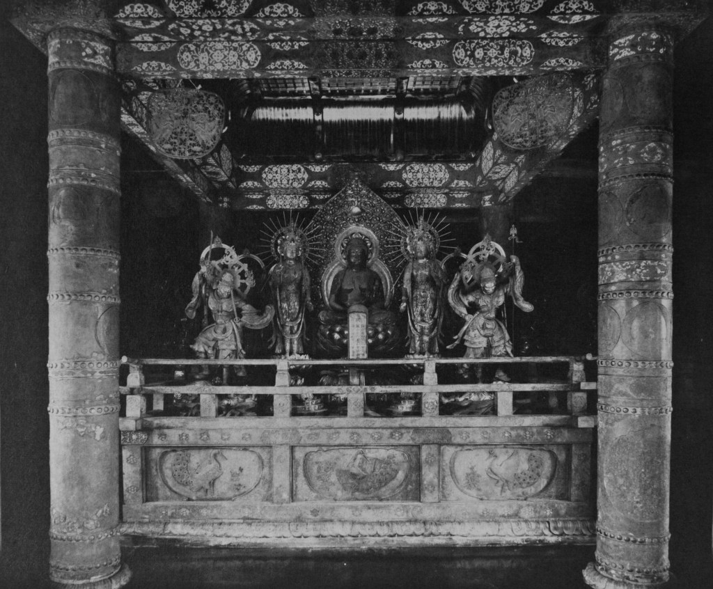 Black-and-white photograph of a Konjikido altar with a seated Amida Buddha flanked by attendant figures, between decorated pillars under an ornate canopy